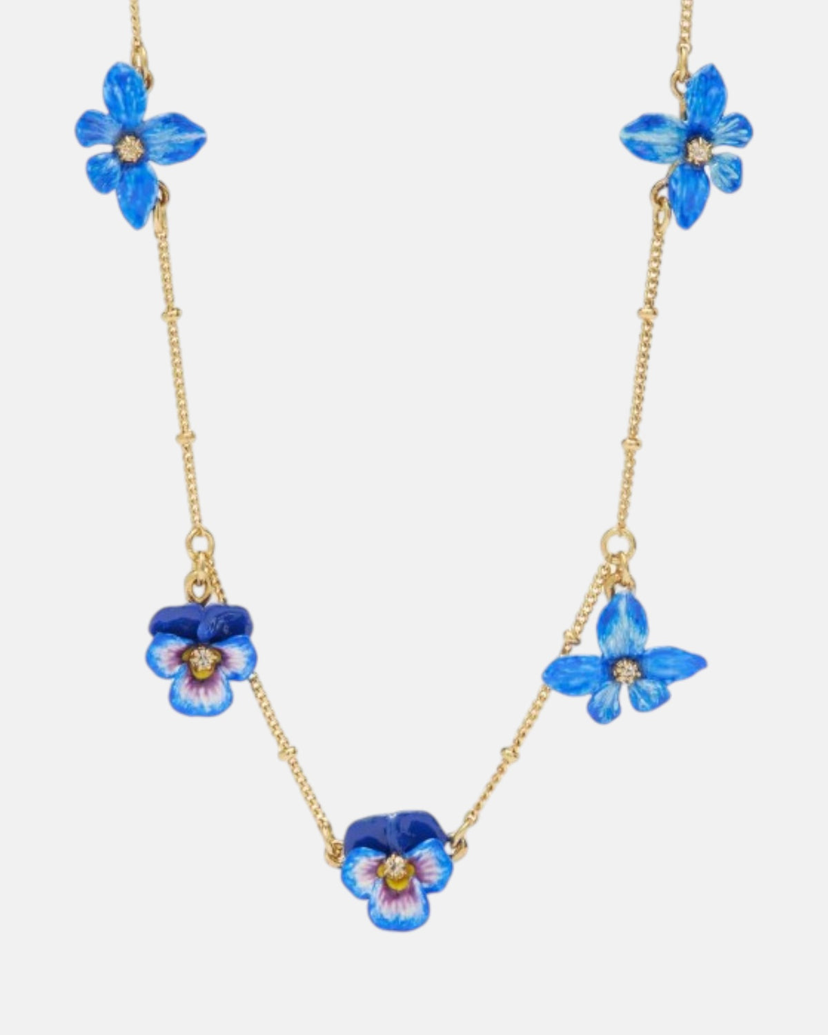 Collar fino de Les Néréides bañado en oro con colgante de flor pensamiento azul esmaltada y cristal facetado central.