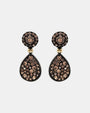 Pareja de pendientes articulados Bohemme con botón circular y lágrima en pavé de circonitas champagne.