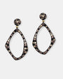 Pareja de pendientes Bohemme Musa de silueta irregular en plata envejecida con circonitas negras y champagne.