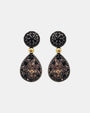 Pareja de pendientes articulados Bohemme con degradado de circonitas de negro a champagne sobre plata oxidada.