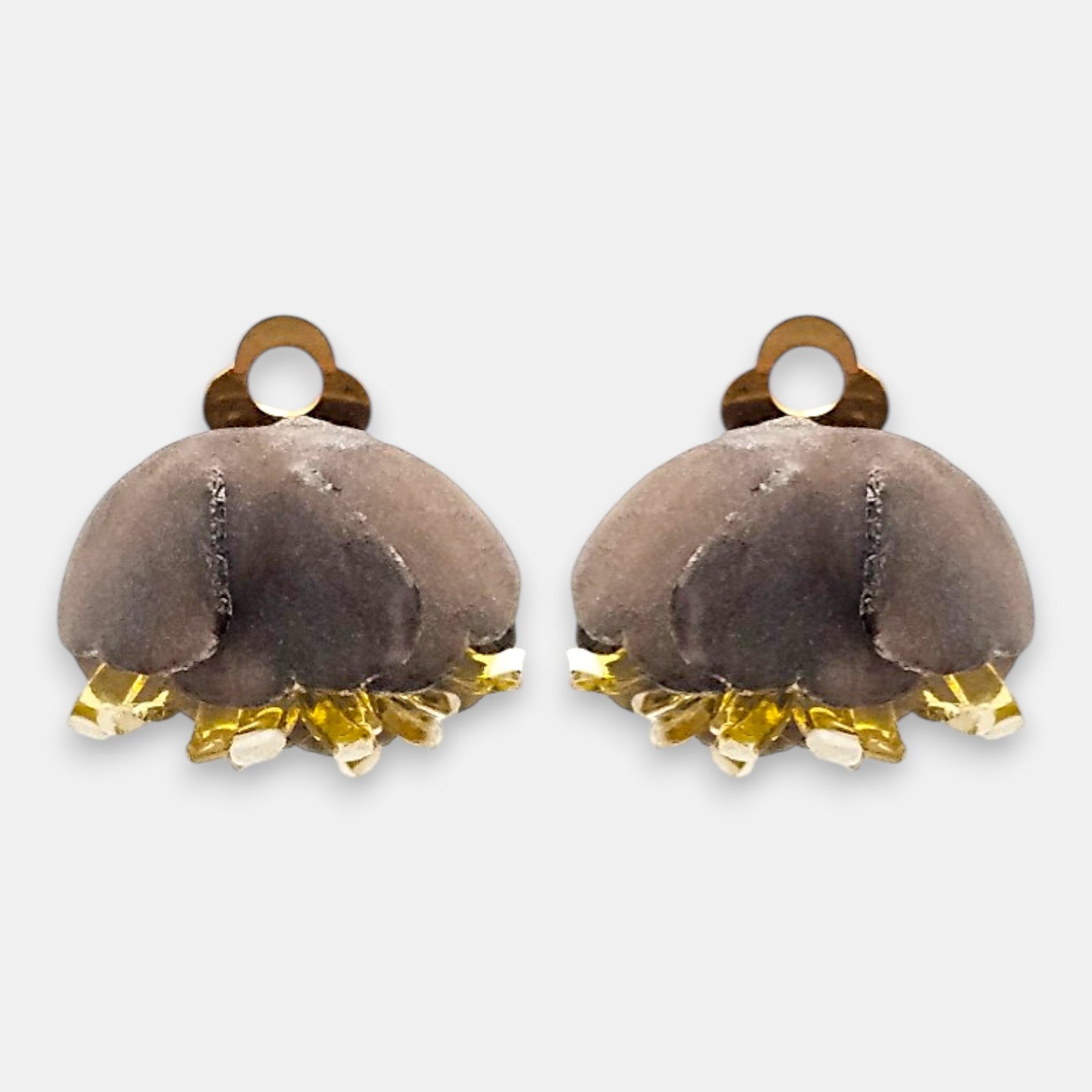 Pareja de pendientes de pinza en forma de concha marina de Ciléa Paris, mostrando su color azul marino satinado y sus detalles en tono crema.