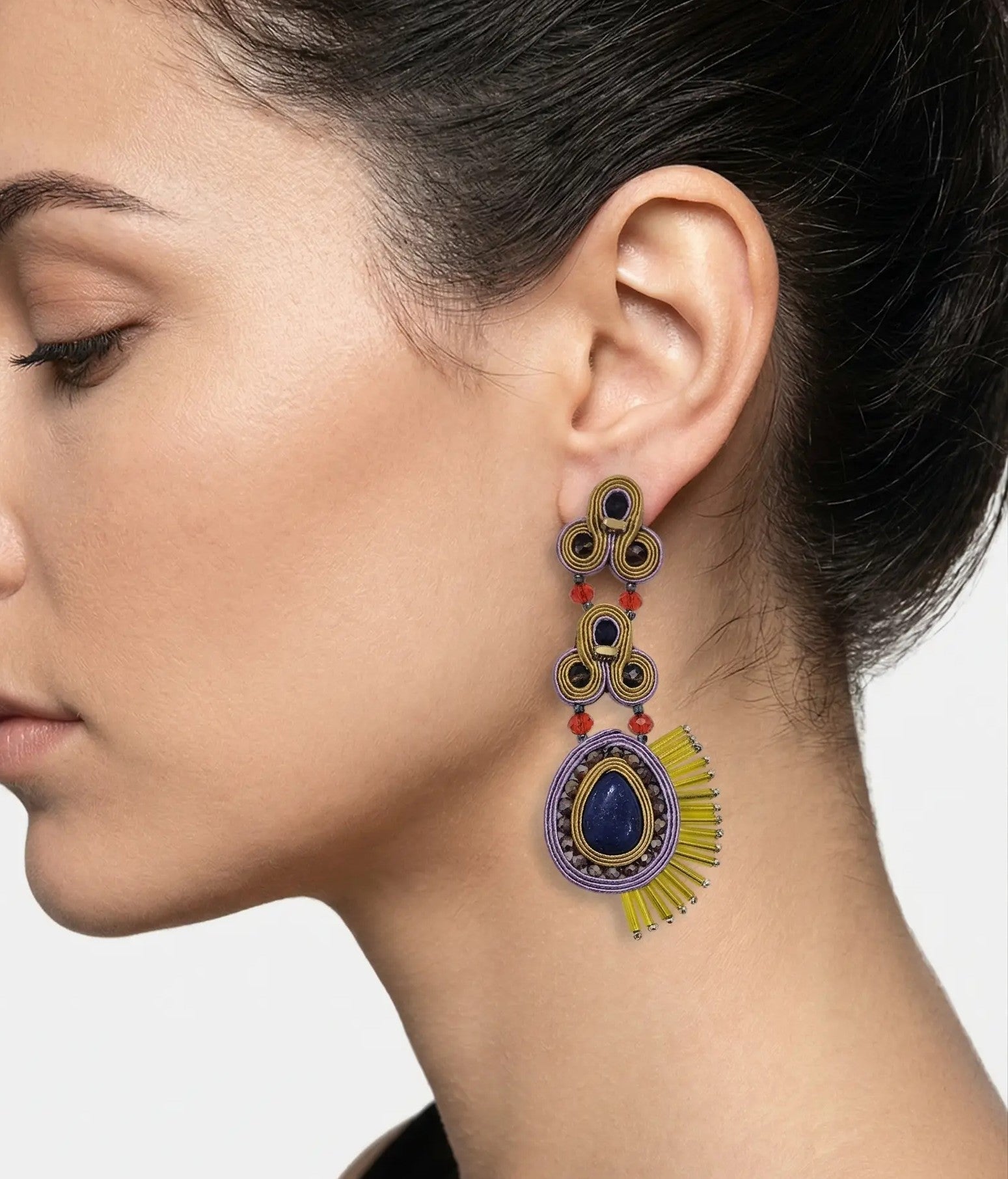 Mujer luciendo los pendientes Micaela Lima, resaltando el contraste del azul lapislázuli con la seda lila y dorada.