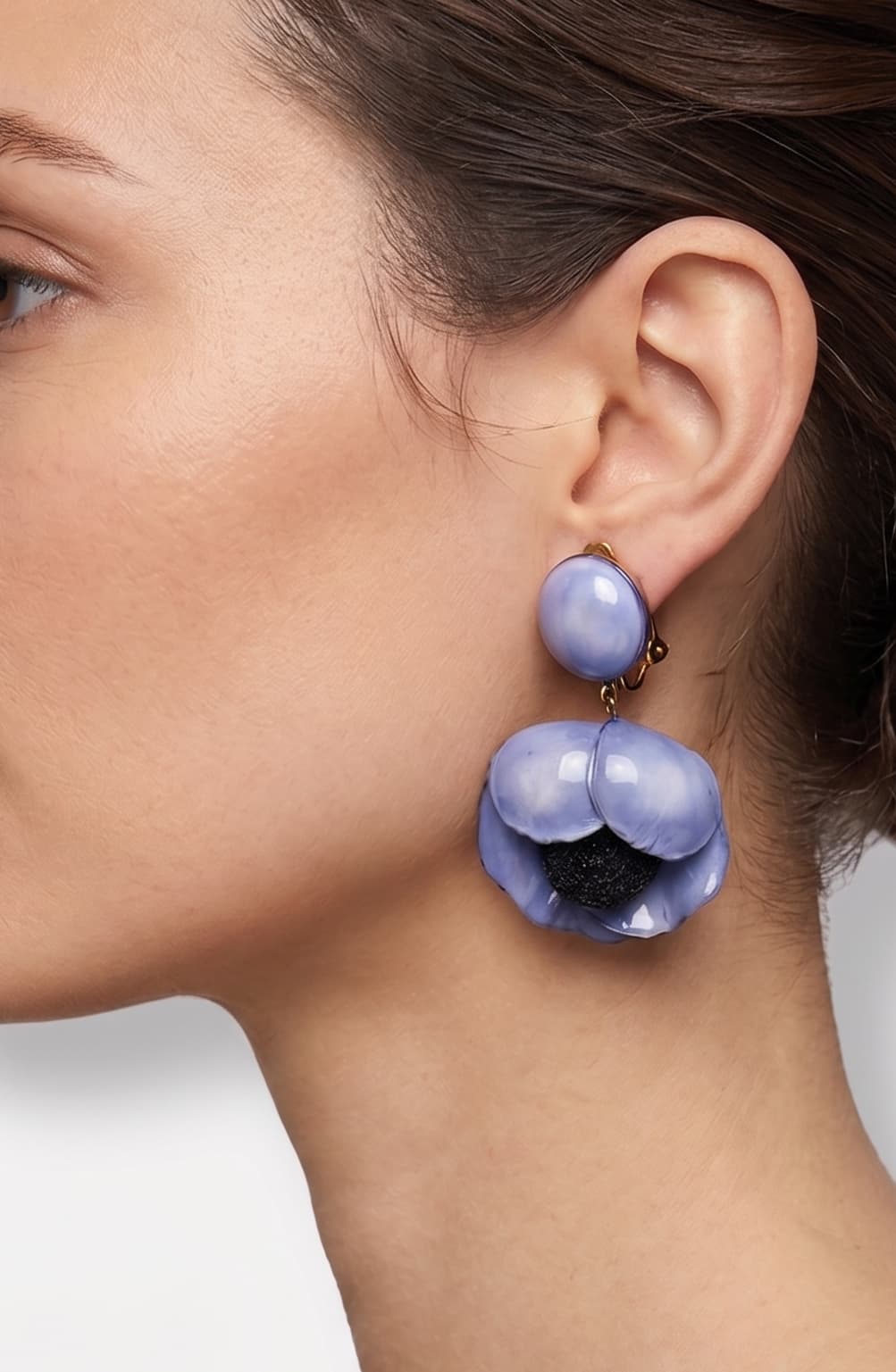 Vista de perfil de los pendientes de hoja negra de Ciléa Paris colocados en una modelo, detallando su volumen maxi y cómo se asientan con su cómodo sistema de pinza.