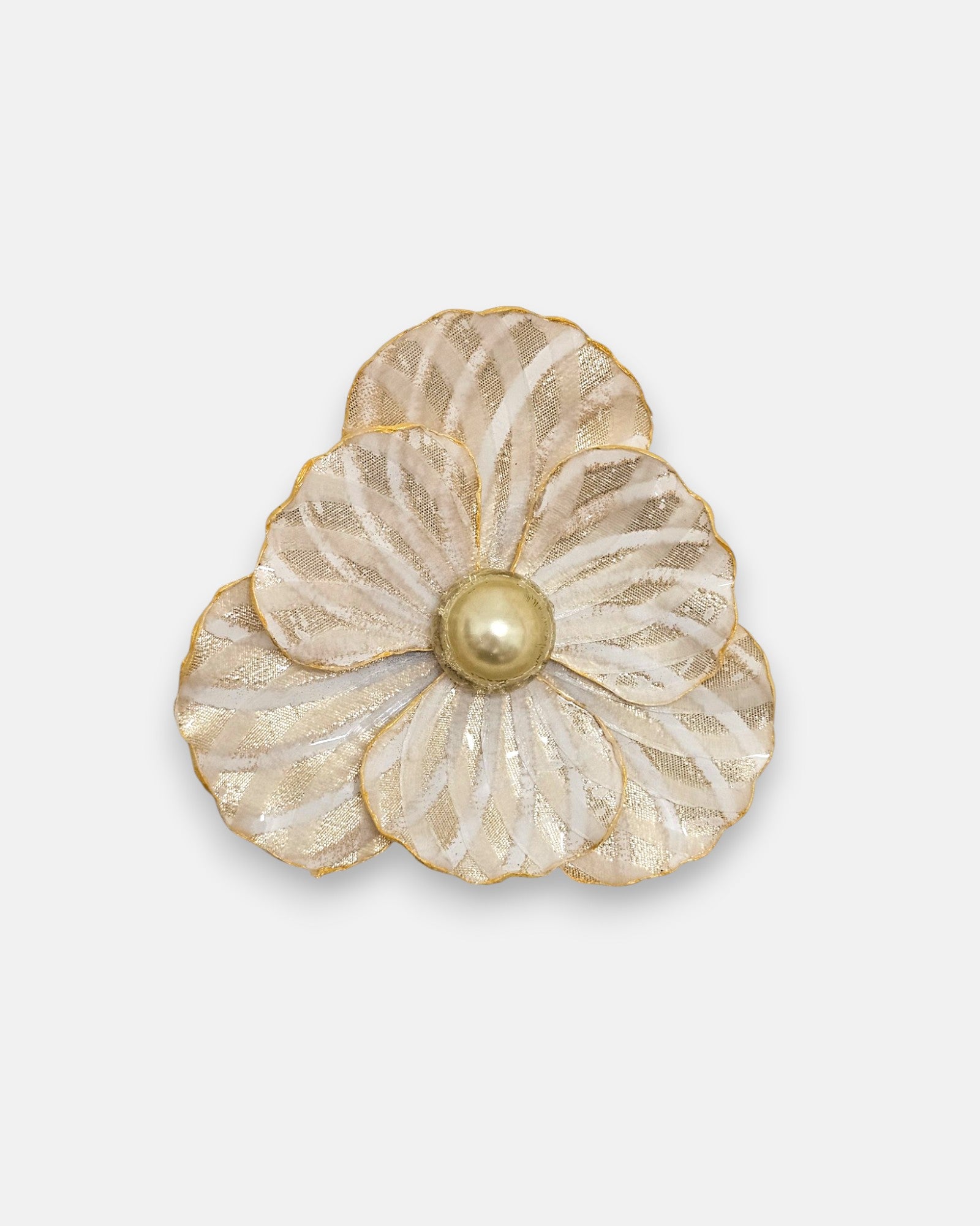 Gran broche maxi en forma de flor camelia de Ciléa Paris, mostrando sus pétalos crema nacarados con rayas doradas y su gran centro perlado champán.