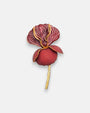 Broche maxi en forma de flor iris de Ciléa Paris, mostrando sus pétalos burdeos estriados con vetas doradas, base redonda granate mate y tallo de oro.