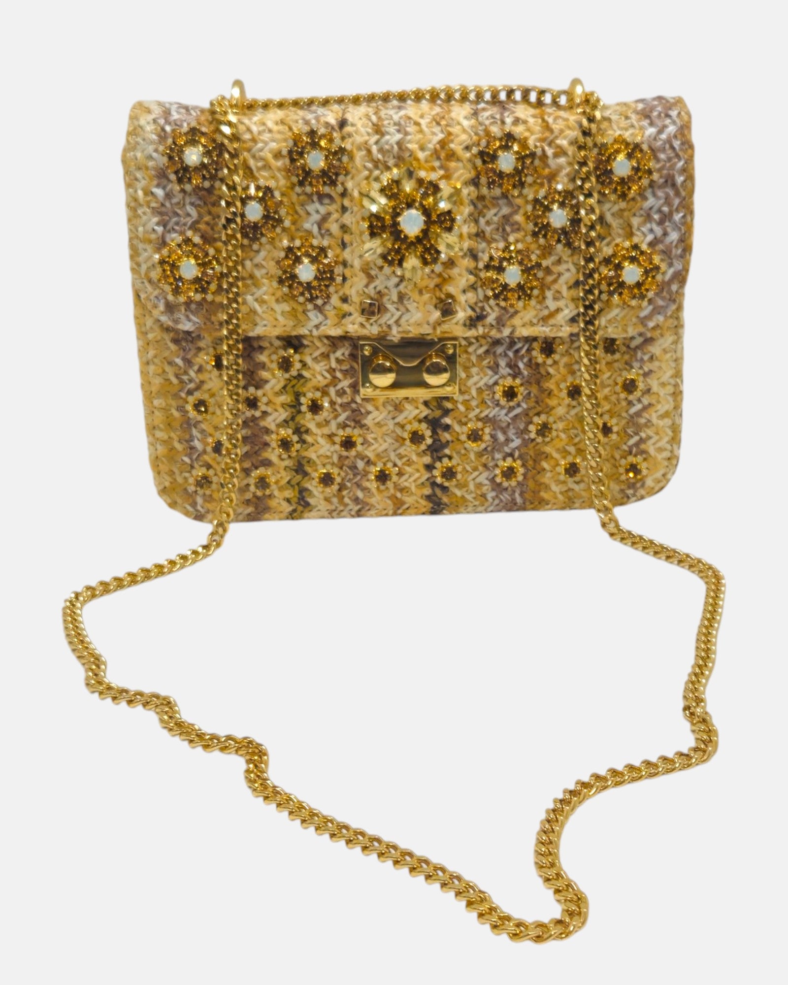 bolso textil de Emanuela Caruso en su totalidad sobre un fondo neutro, exhibiendo la caída fluida de su larga correa de eslabones dorados brillantes.