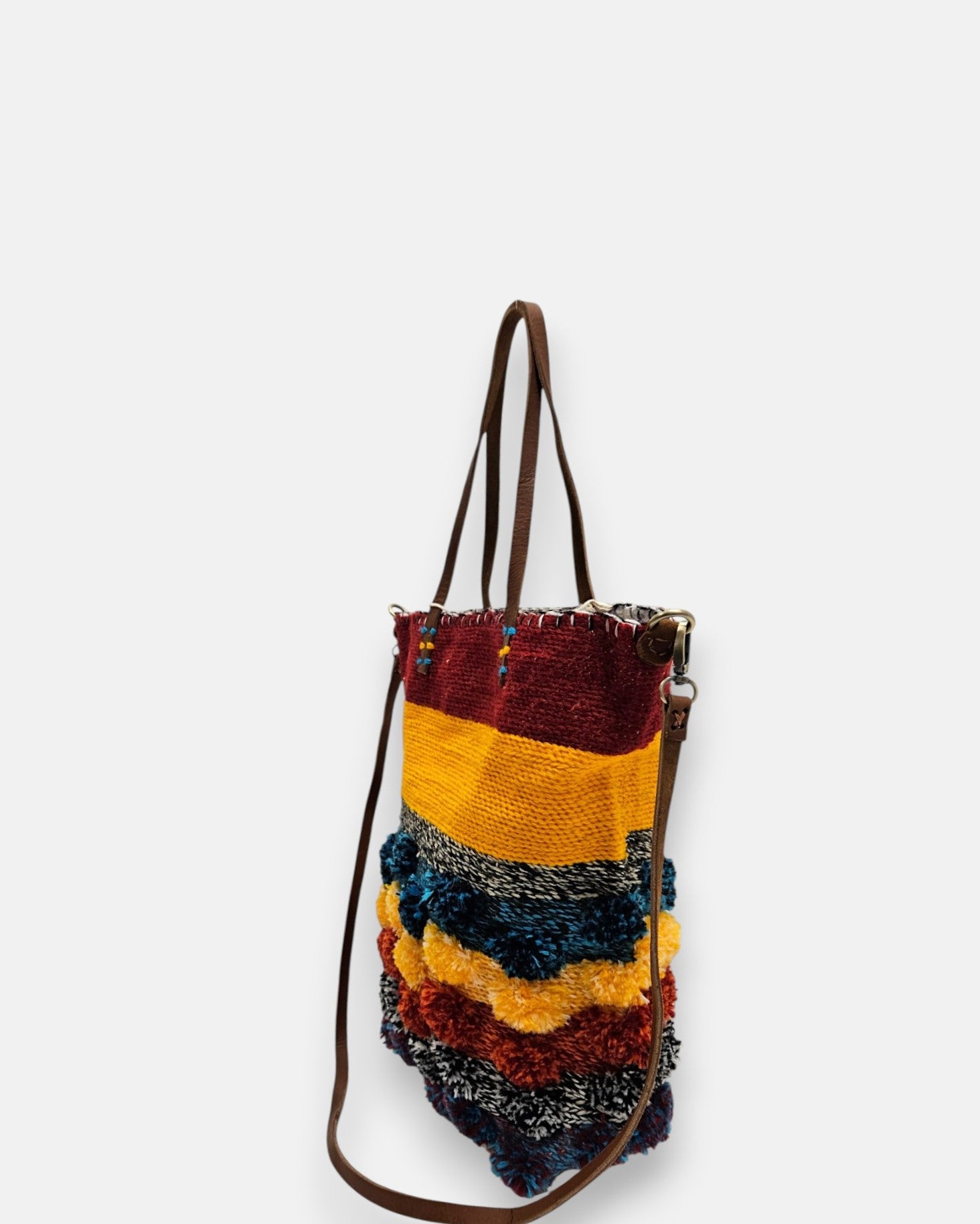 Mujer luciendo el bolso "Atardecer Bereber" como bandolera, resaltando su colorido diseño étnico.