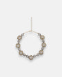 Collar gargantilla de flores Tataborello extendido en círculo mostrando su hilera continua de rosetones dorados con cristales y cadena de ajuste.