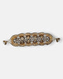 Maxi pulsera ancha Tataborello extendida con eslabones en forma de abanicos dorados, cristales y cierre magnético.