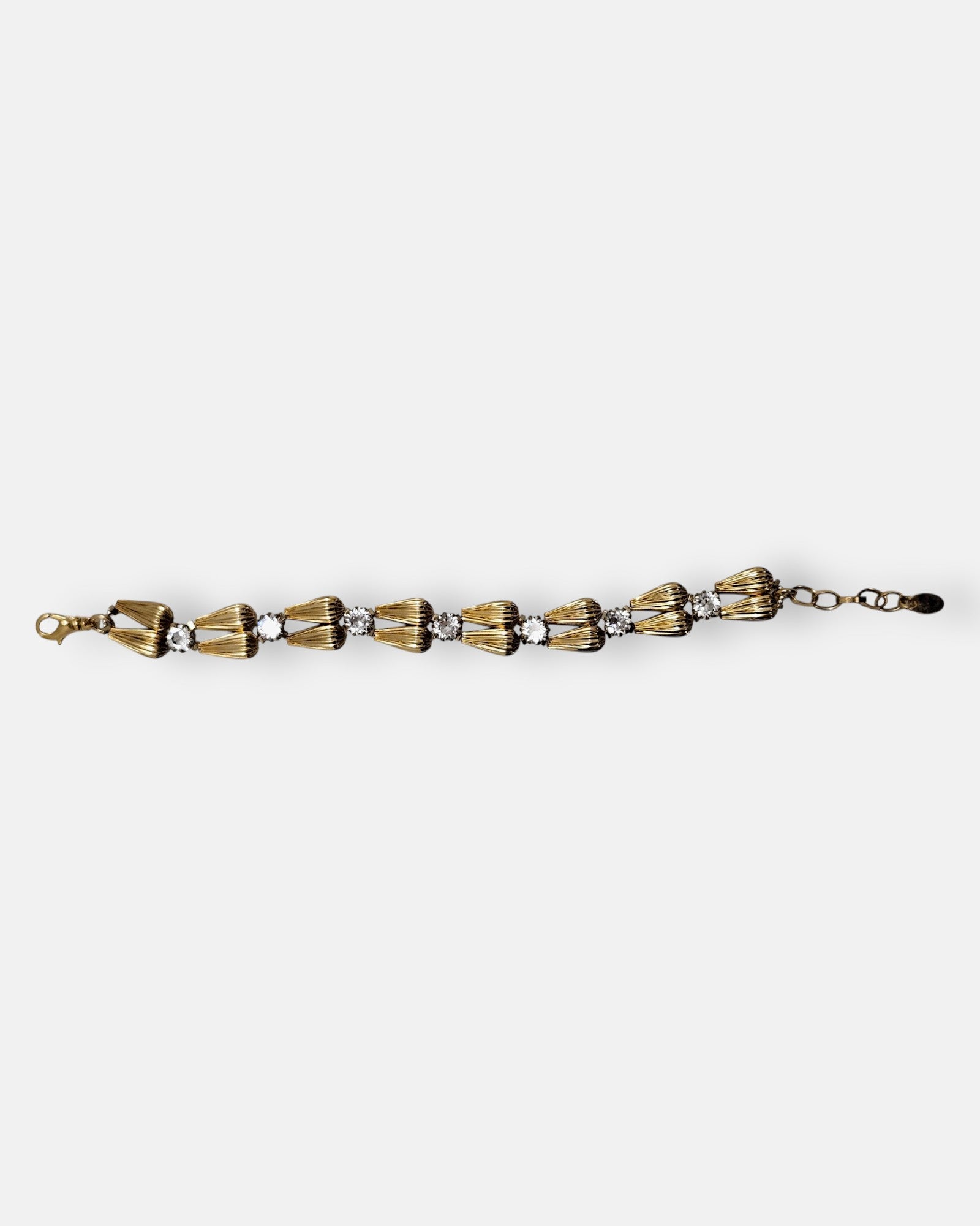 Pulsera fina Tataborello extendida con parejas de eslabones dorados en forma de gota y cristales brillantes.