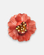 broche en forma de flor abierta de Ciléa Paris con pétalos estriados en color rojo coral, un cáliz central elevado y pistilos texturizados.