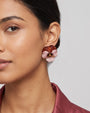 vista de perfil del pendiente Pensée de Ciléa Paris colocado en el lóbulo de una modelo, luciendo su escala media, su brillo satinado y su elegante ajuste.
