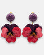 pareja de pendientes colgantes maxi con forma de flor de pensamiento de Ciléa Paris, destacando sus pétalos superiores en color violeta oscuro, pétalos inferiores en rojo rubí brillante y un gran botón superior esférico a juego con enganche de pinza.