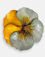 plano macro del centro de la flor del broche, enfocando las finas líneas oscuras pintadas de forma artesanal y el pistilo texturizado en relieve dorado.