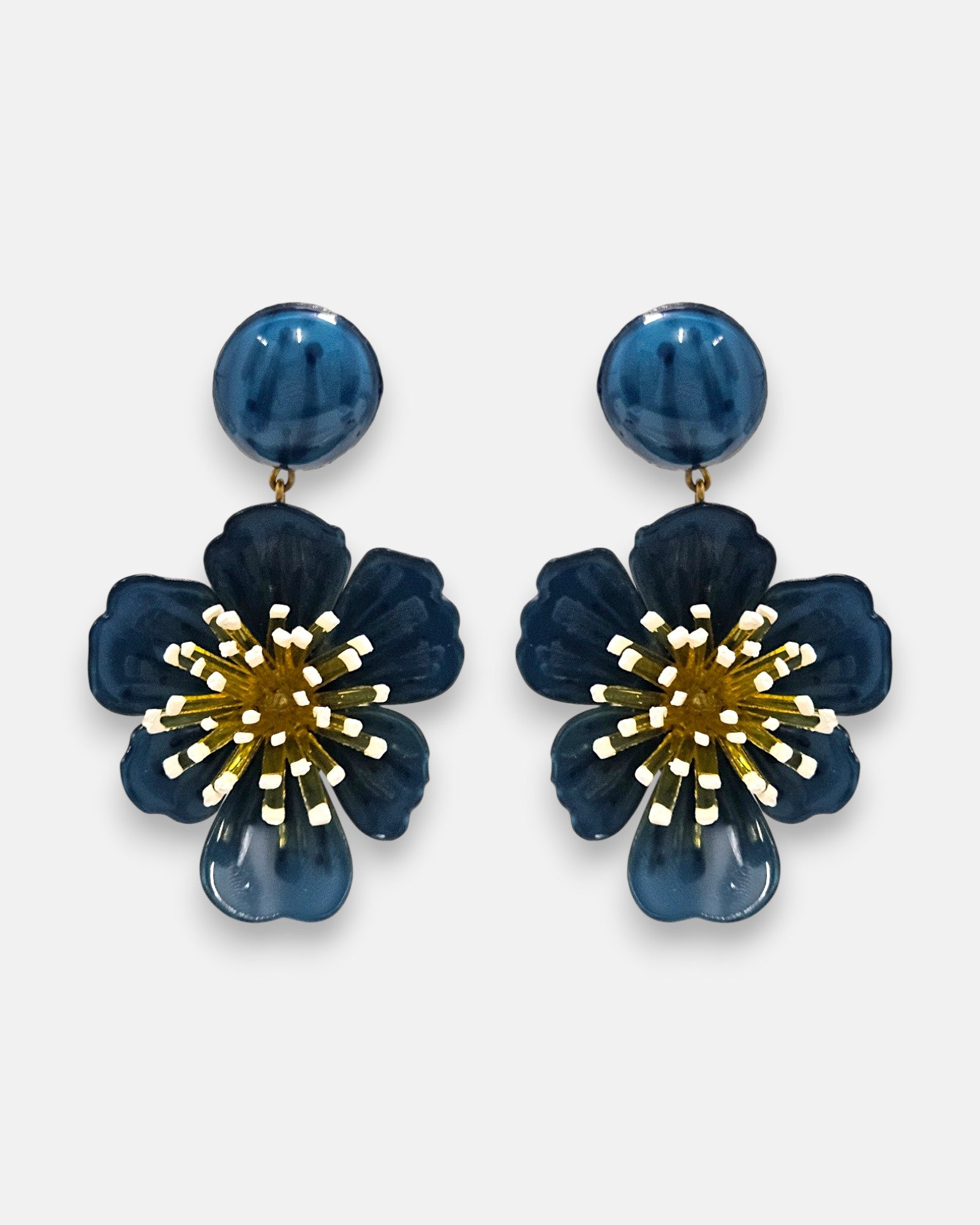pareja de pendientes colgantes maxi con forma de flor de anémona de Ciléa Paris, destacando sus pétalos de resina en color azul petróleo brillante, un complejo centro de pistilos dorados con puntas blancas y un botón superior esférico de perno coordinado.