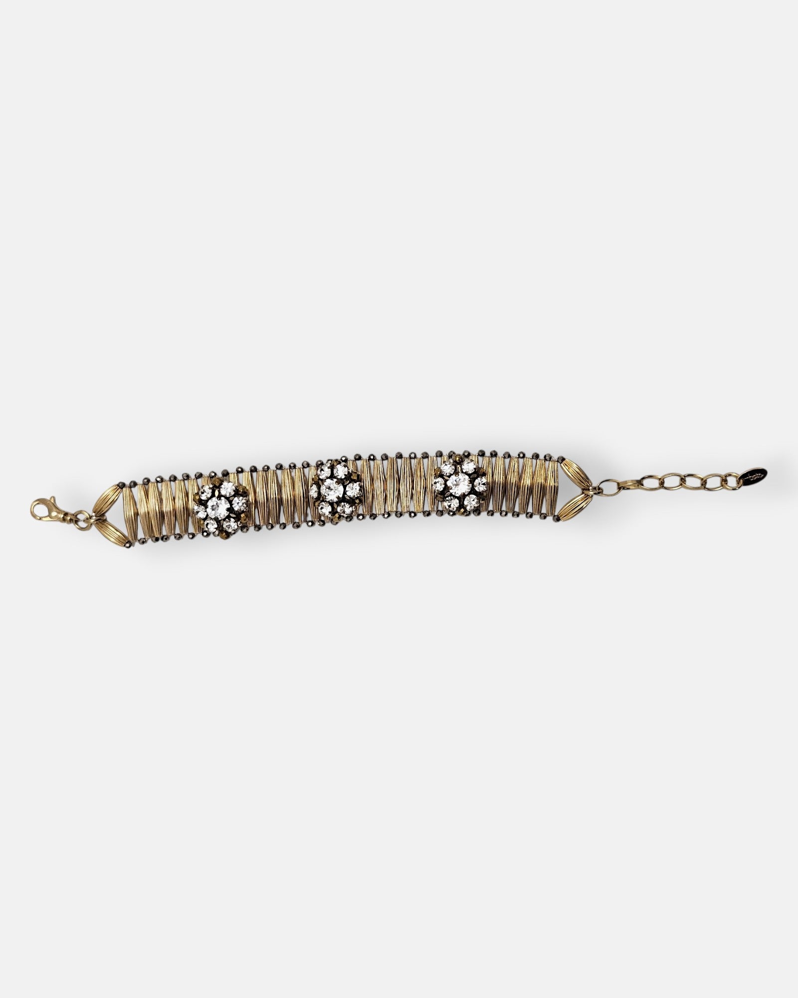 Pulsera Tataborello extendida mostrando la hilera de brotes articulados dorados con perfilado oscuro.