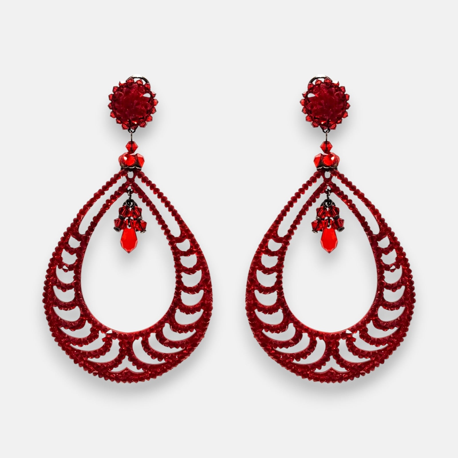Pareja de pendientes de fiesta grandes de gota Piel de Carmín de la firma Dublos, mostrando su diseño de lágrima calada texturizada en rojo vibrante.