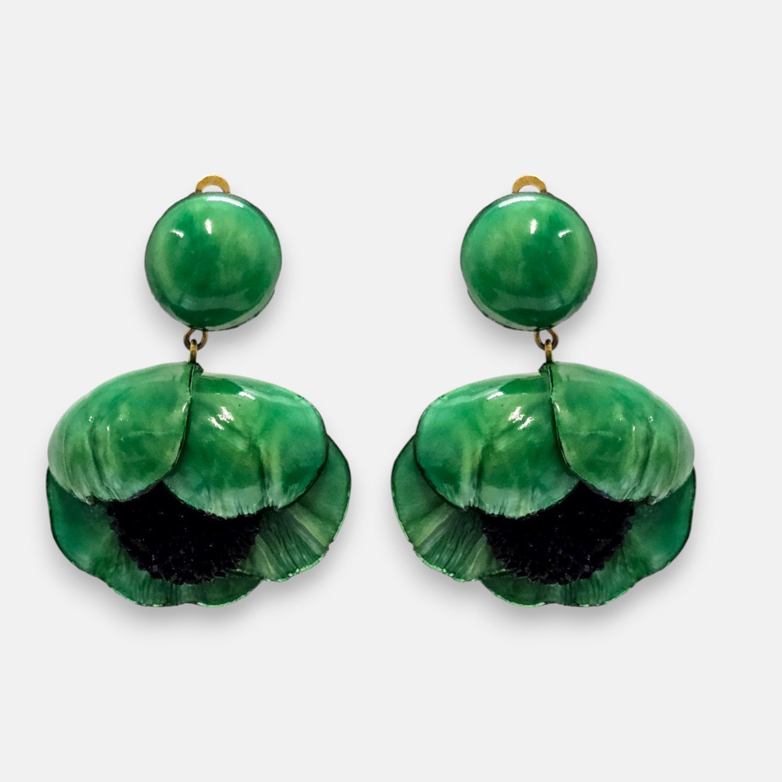 par de pendientes de clip con forma de flor de amapola de Ciléa Paris, detallando su botón superior redondo con la pequeña pestaña del cierre de pinza asomando y sus pétalos verde esmeralda.