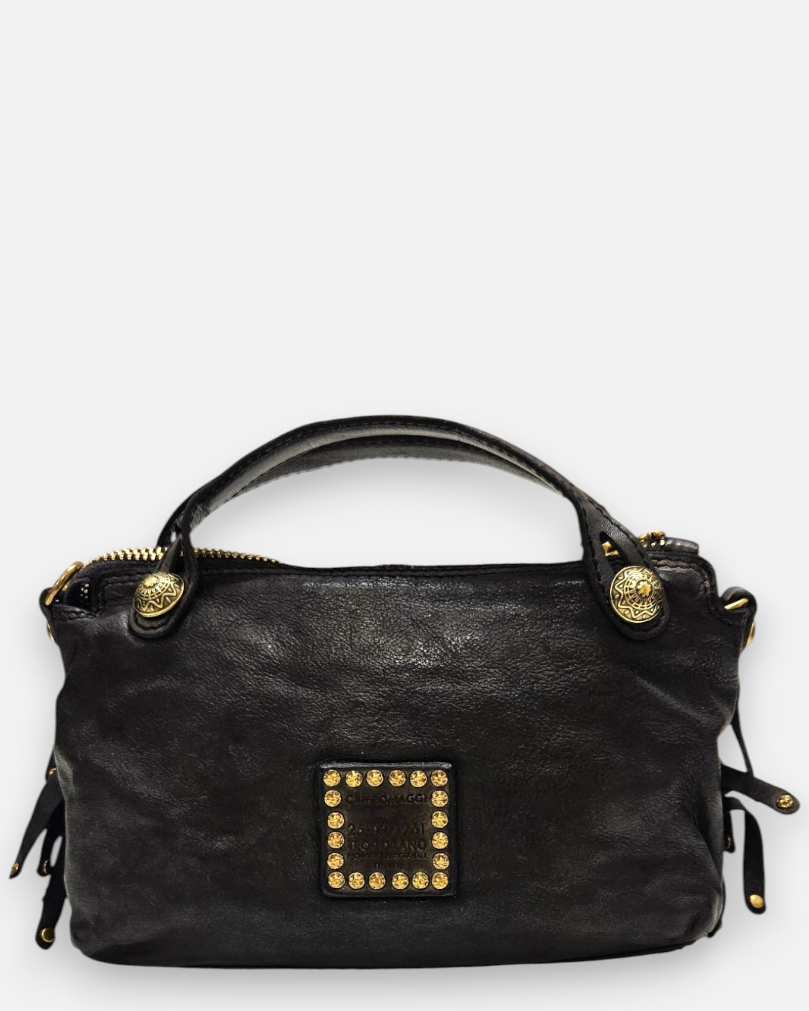 reverso en piel lisa del bolso Neha, detallando en el centro el parche cuadrado de piel con tachuelas doradas envejecidas.