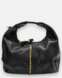 bolso Valentina de piel azul oscuro grisáceo, destacando su tira vertical central de tachuelas doradas y su asa de mano integrada.