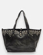 bolso Chiara de piel gris, destacando su franja superior ornamentada con cristales y apliques florales metálicos junto a sus asas dobles.