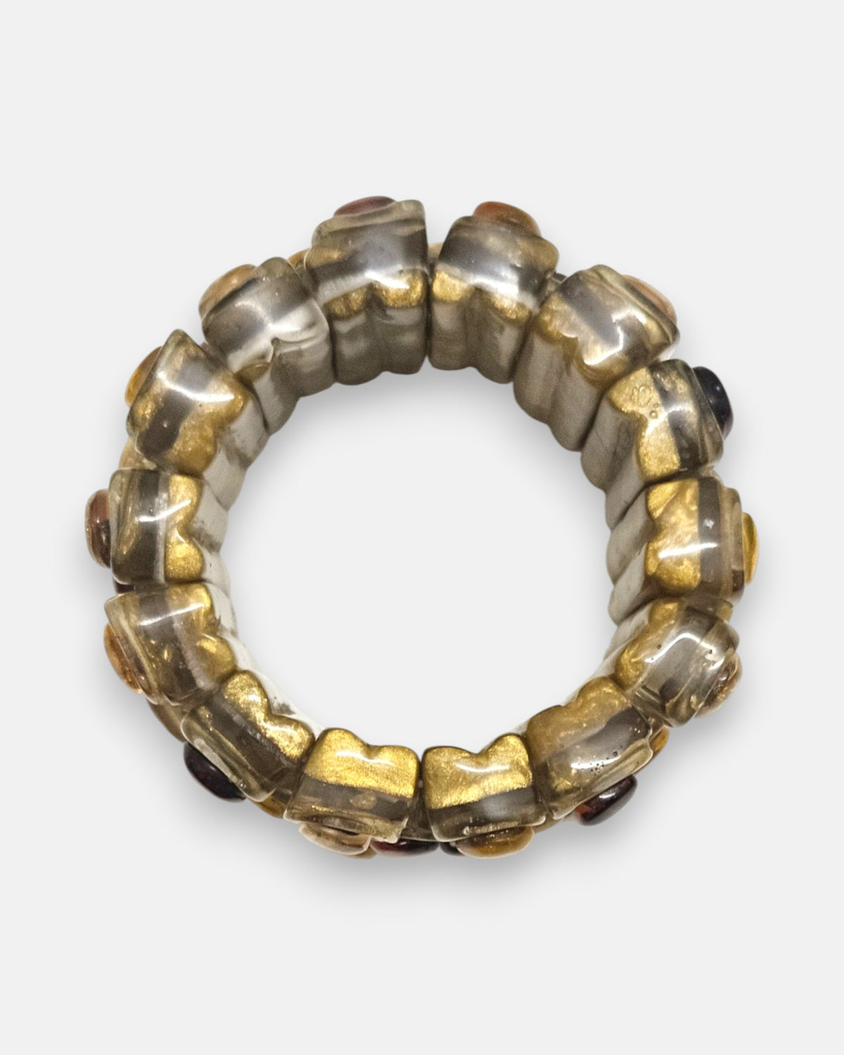 vista circular cenital de la pulsera elástica Miel Garance, detallando la flexibilidad de sus bloques de resina dorada.