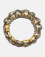 vista circular cenital de la pulsera elástica Garance Argent, detallando la flexibilidad de sus bloques de resina dorada.