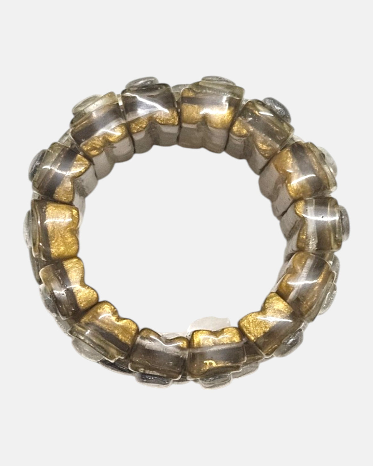 vista circular cenital de la pulsera elástica Garance Argent, detallando la flexibilidad de sus bloques de resina dorada.
