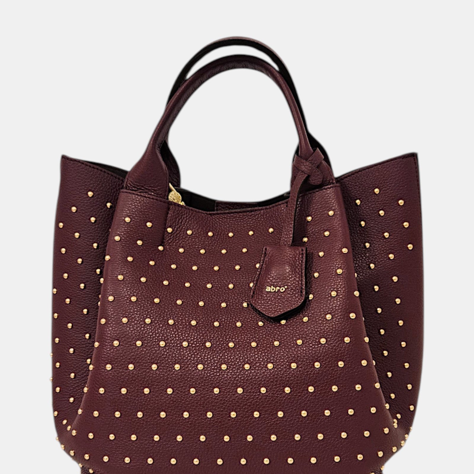 Bolso shopper burdeos con tachuelas doradas