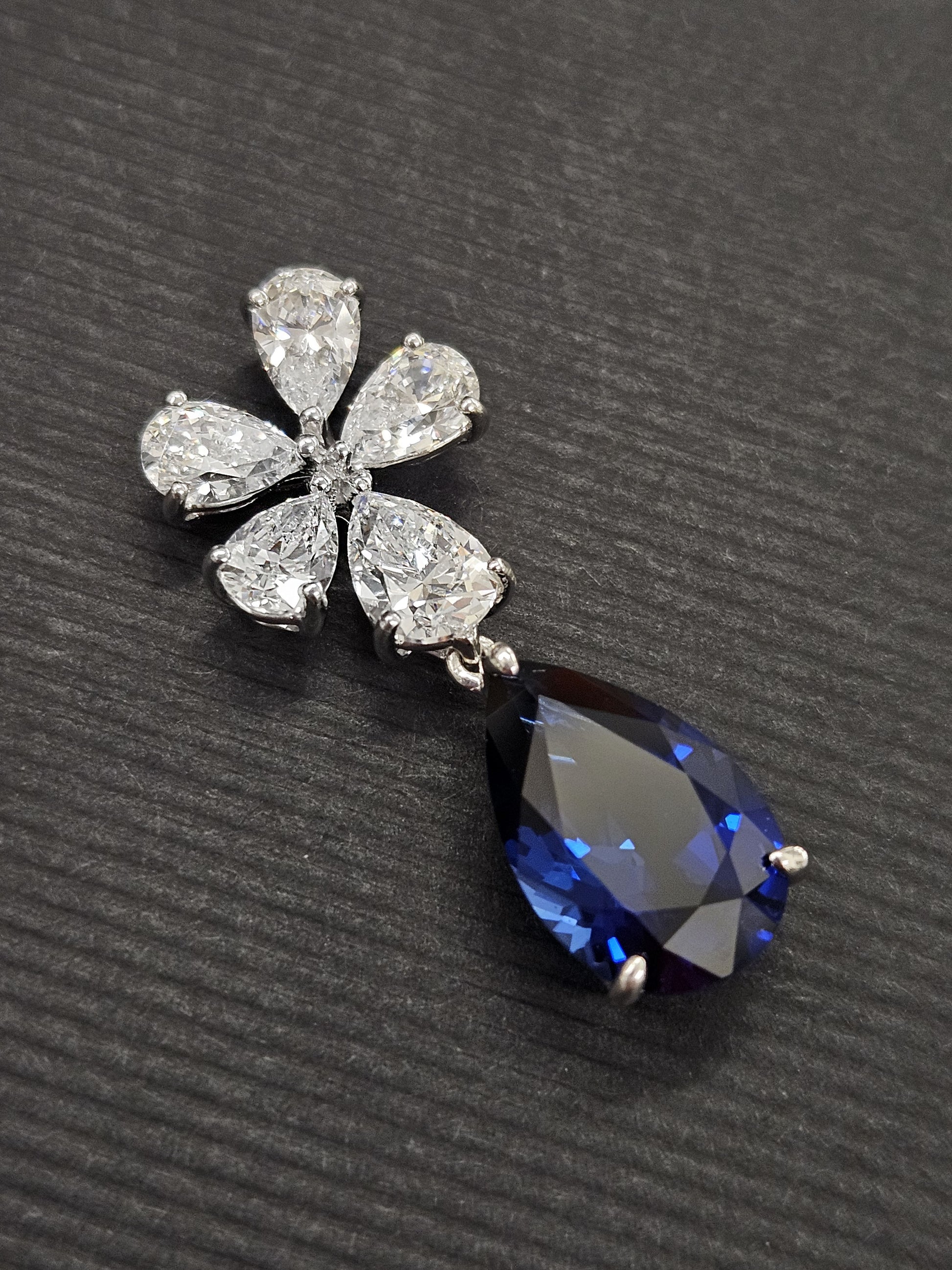 Silver flower pendant with sapphire teardrop cubic zirconia 