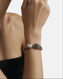 modelo luciendo la pulsera Sibilla en la muñeca, apreciando la escala escultural de la caña y el contraste de sus dos gemas.