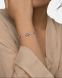 modelo luciendo la pulsera Elettra en la muñeca, apreciando el contraste entre las perlas y la plata oscura.