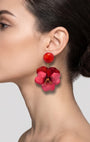 vista de perfil del pendiente de pensamiento rojo de Ciléa Paris colocado en el lóbulo de una modelo, detallando su imponente caída, su escala extra grande de 7x5 cm y su textura esmaltada.