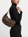 modelo luciendo el bolso Monalisa colgado al hombro, apreciando su silueta curva, su tamaño medio y su estilo bohemio chic.