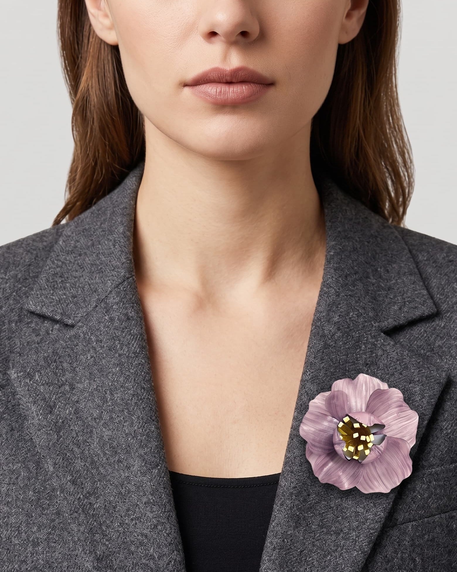 vista frontal del broche de flor de Ciléa Paris colocado en la solapa de una chaqueta de sastre gris, detallando su escala maxi y su elegancia romántica.