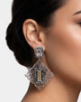 modelo luciendo el pendiente Fleur Baroque de Maria e Luisa en la oreja, apreciando su cierre omega y escala sobre la piel.