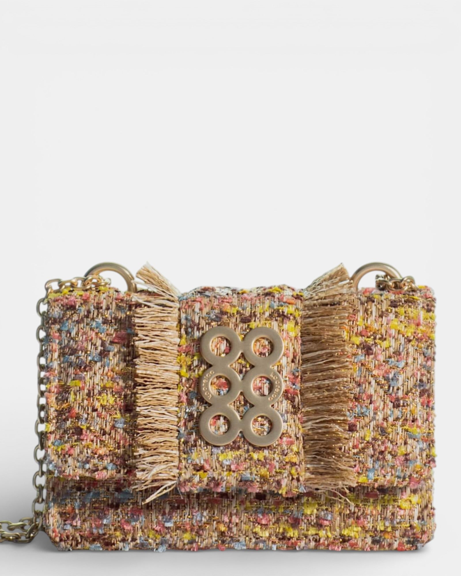 Bolso Kooreloo Lucerne Mini en tweed multicolor amarillo y rosa con bordes deshilachados y logo dorado.