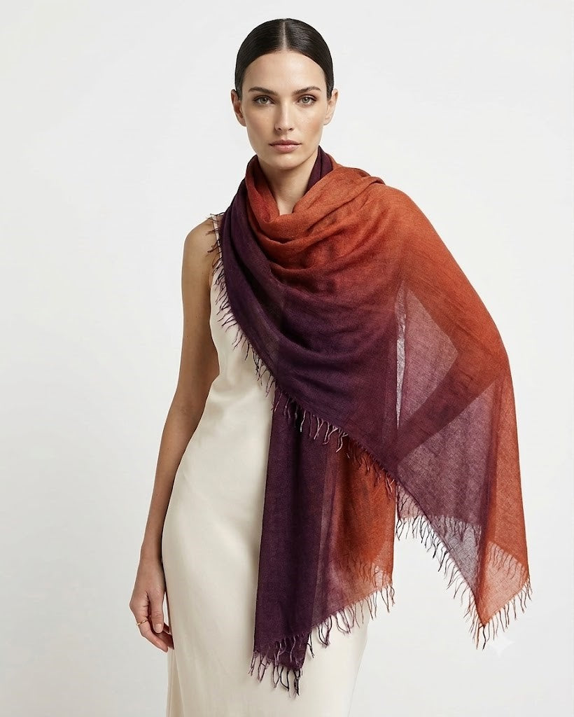 Modelo luciendo el foulard maxi de cashmere y seda Faliero Sarti Enrichetta sobre los hombros combinado con un vestido claro.