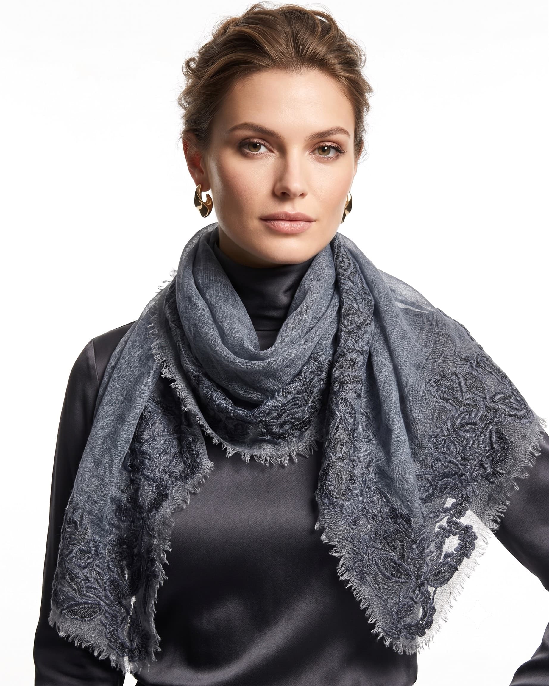 Modelo luciendo el foulard Faliero Sarti Fiorenza en lana azulado con bordes de encaje bordado sobre jersey gris.