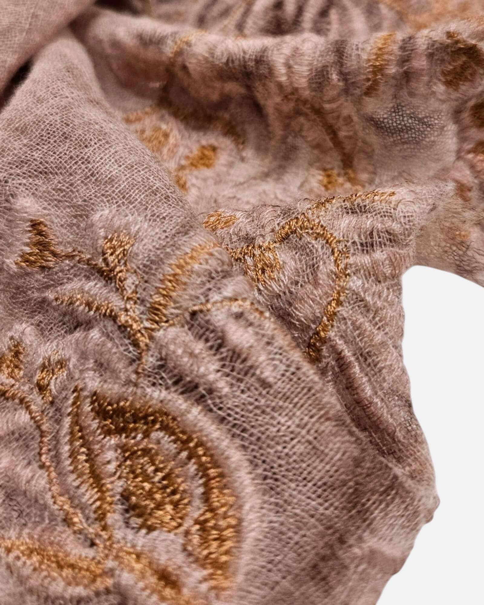 Primer plano en detalle del relieve del bordado dorado y la textura fina de lana del foulard Faliero Sarti Fiorenza.